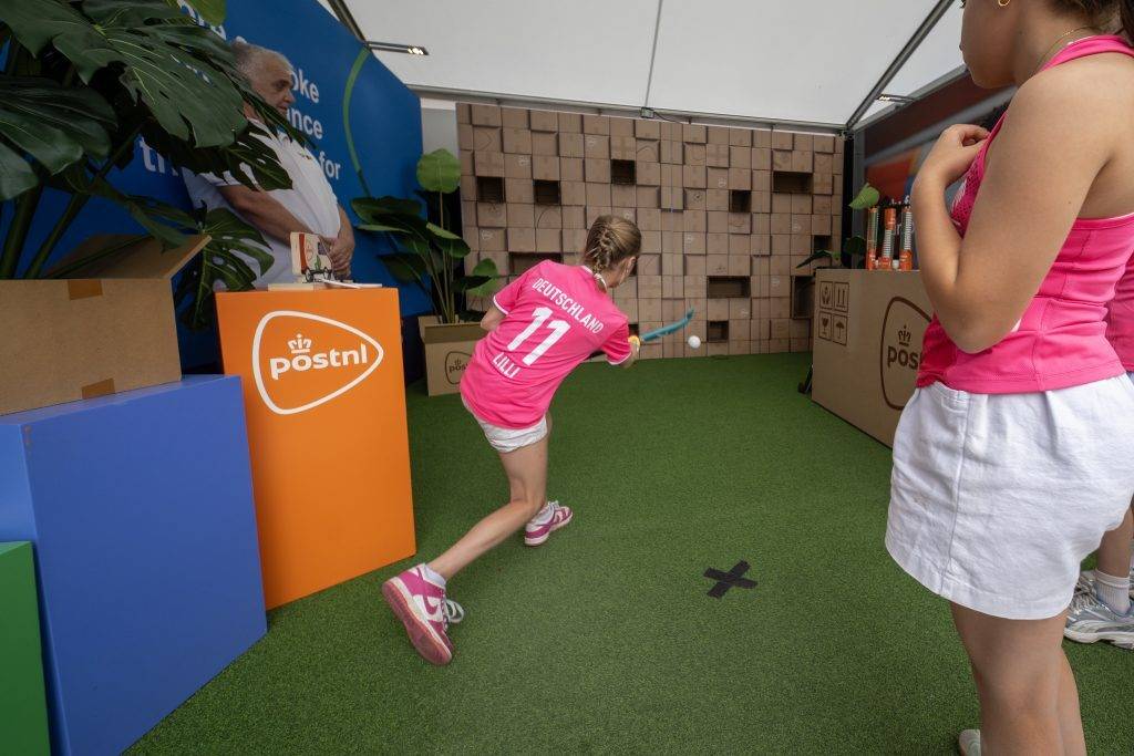 Girl shoots a hockeyball at the PostNL activation stand during the 2026 FIH Hockey World Cup